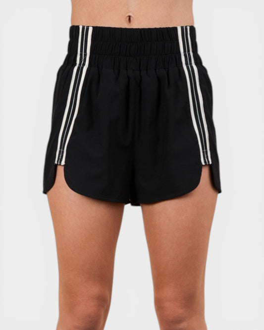 Black shorts with white stripes on a plain background