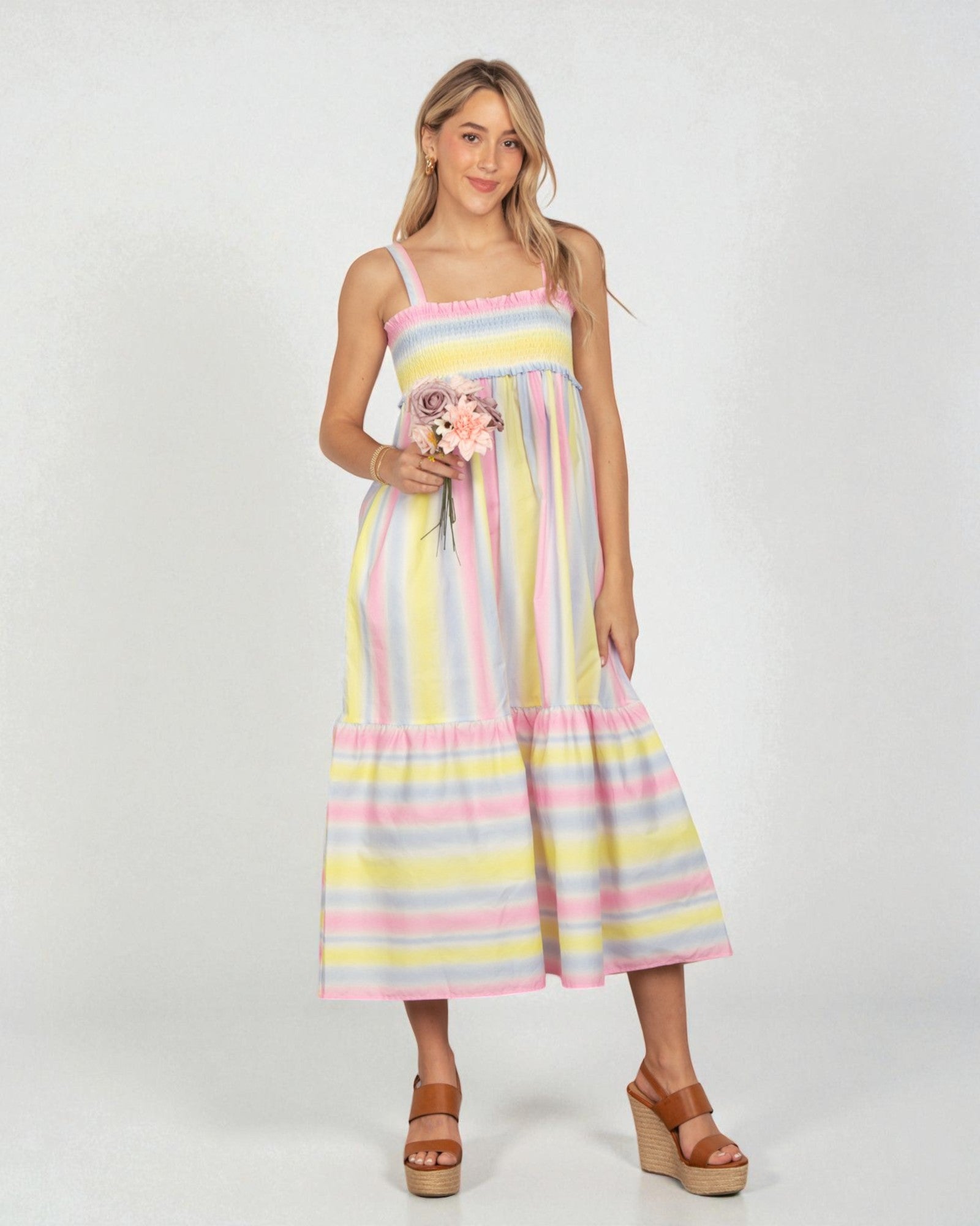 Woman wearing a colorful striped dress on a white background