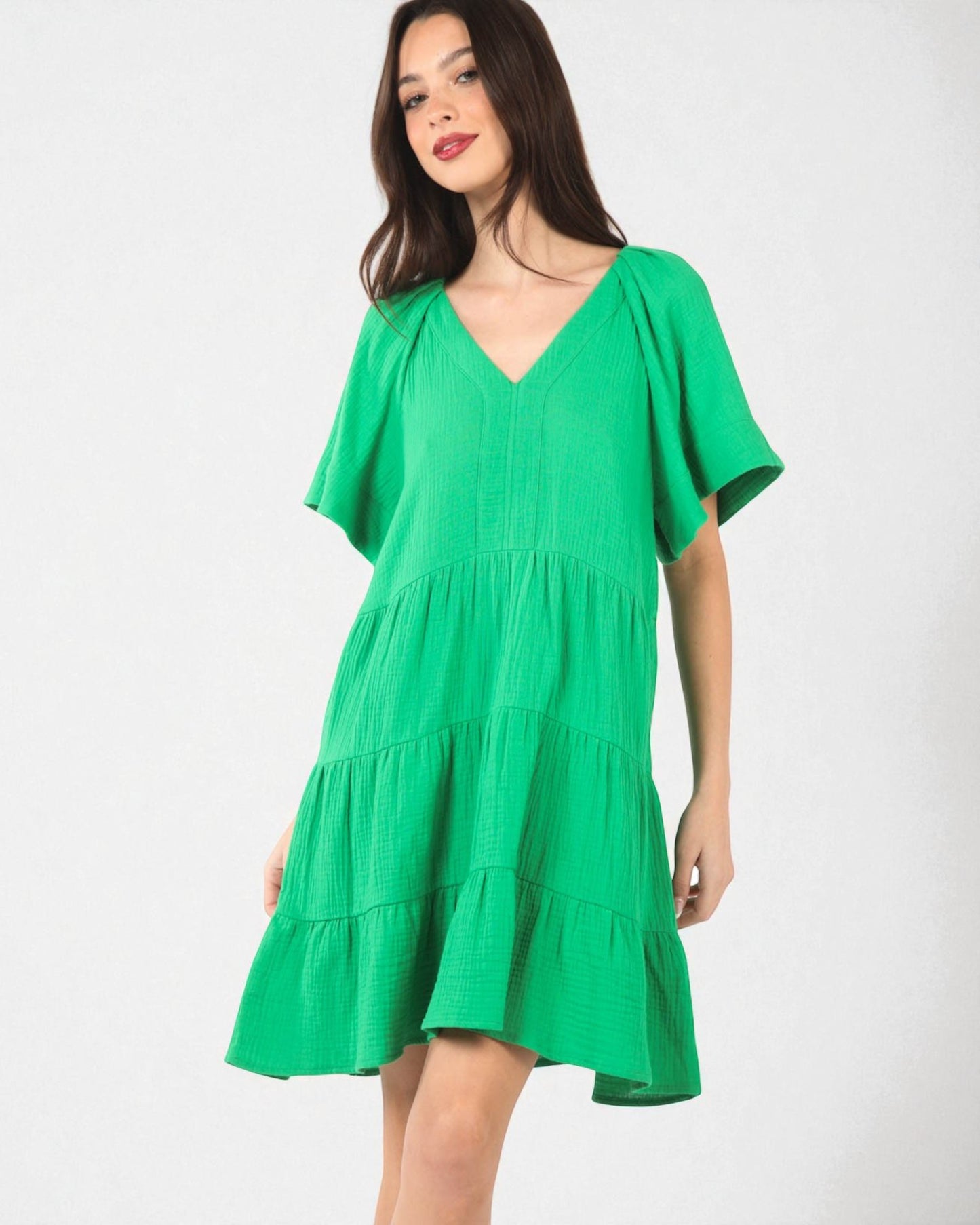 Green dress worn by a model on a white background