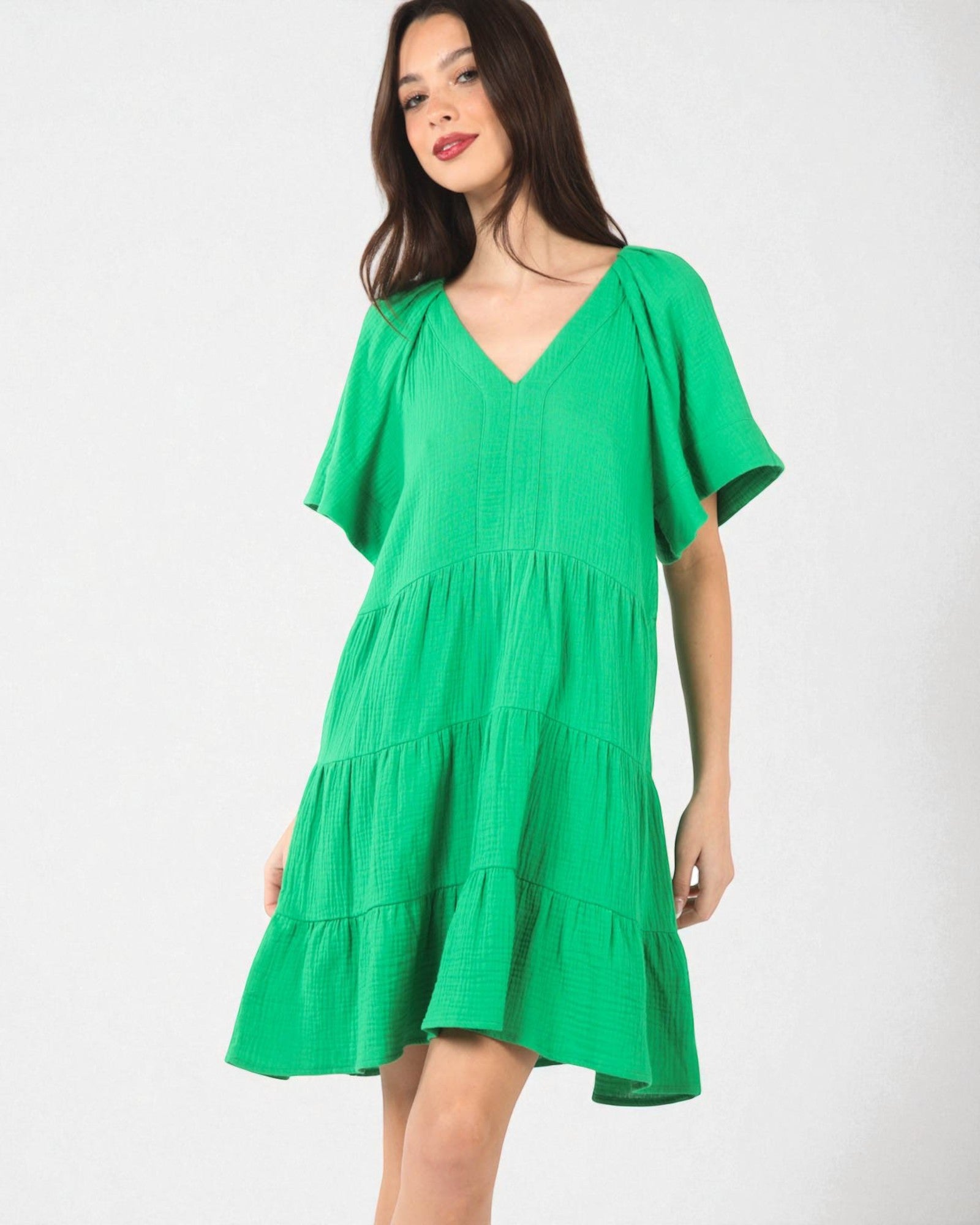 Green dress worn by a model on a white background