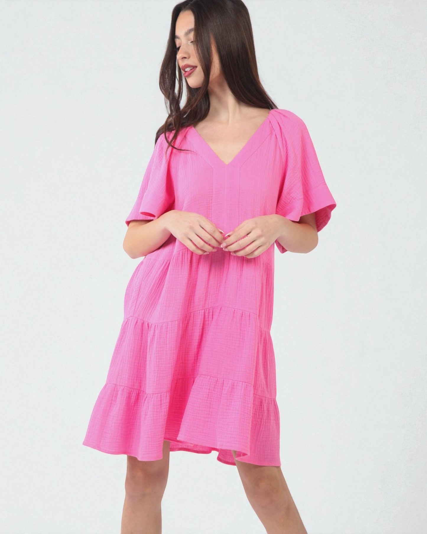 Woman wearing a pink dress on a white background