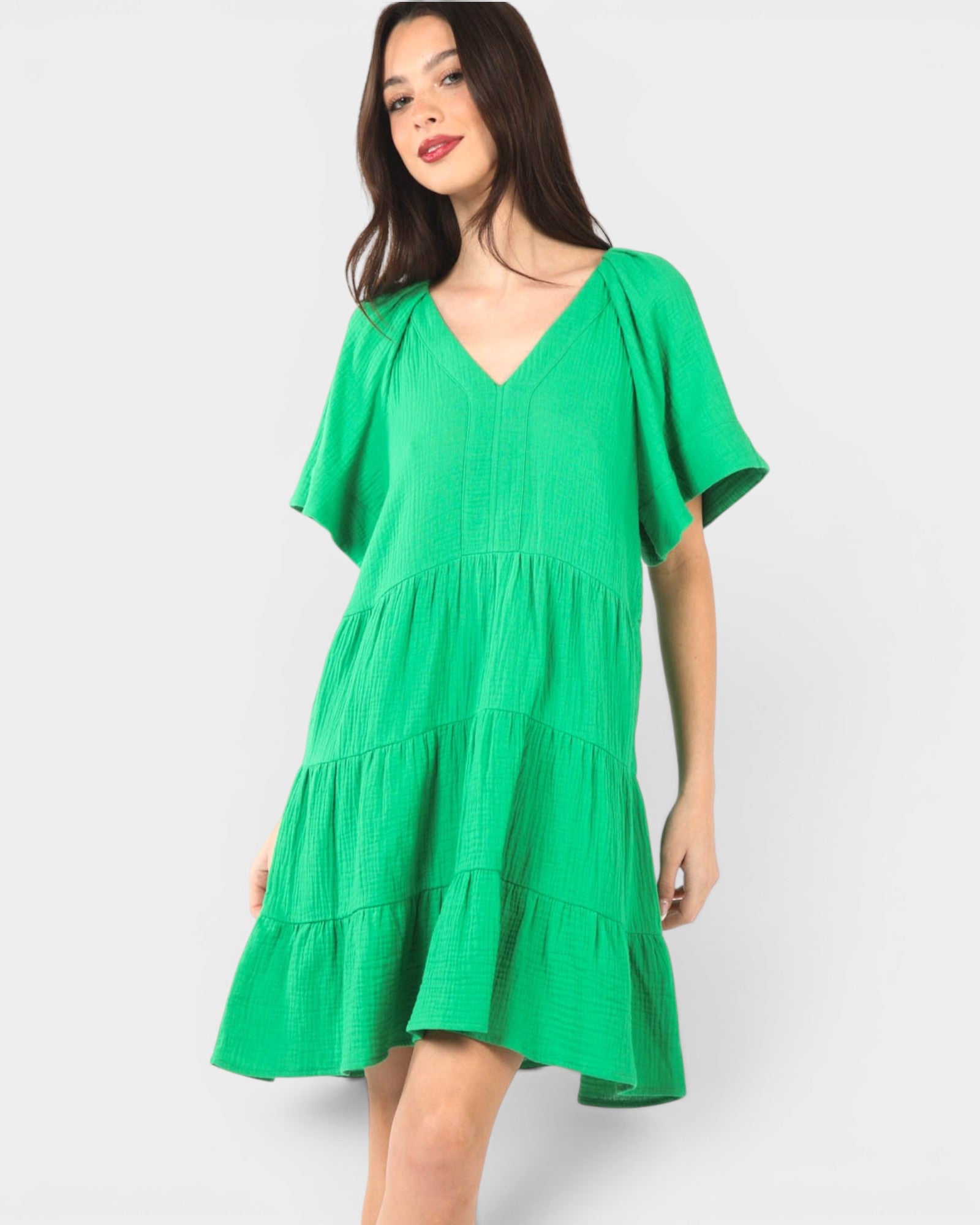 Woman wearing a green dress on a white background