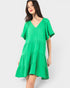 Woman wearing a green dress on a white background