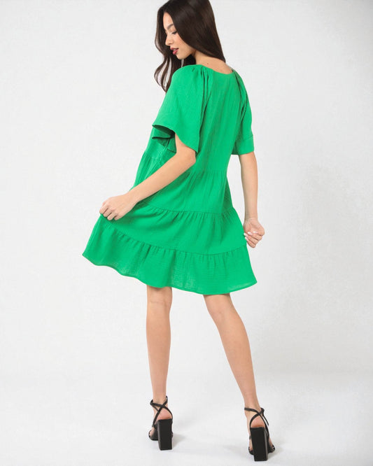 Green dress worn by a model on a white background