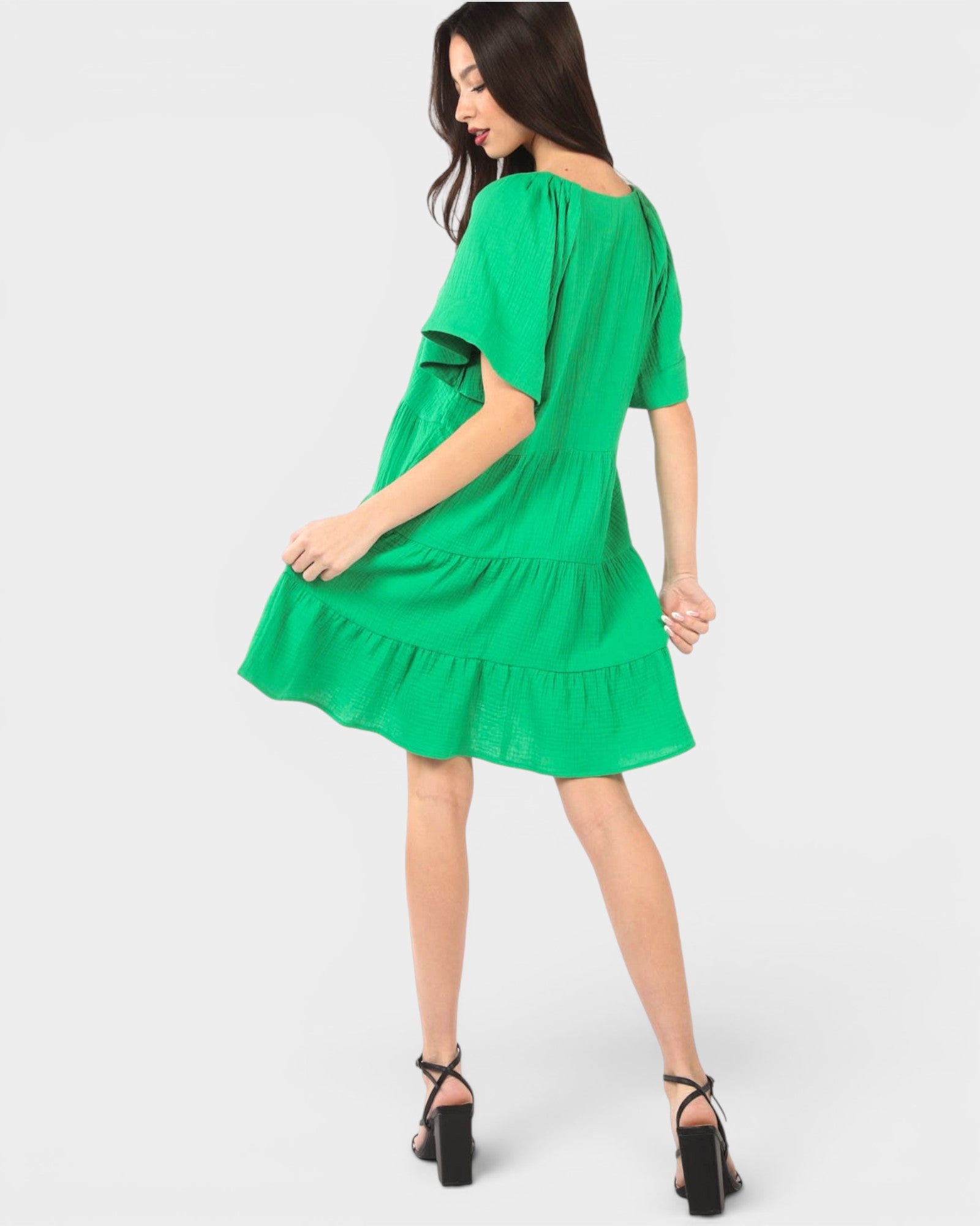 Woman wearing a green dress on a white background