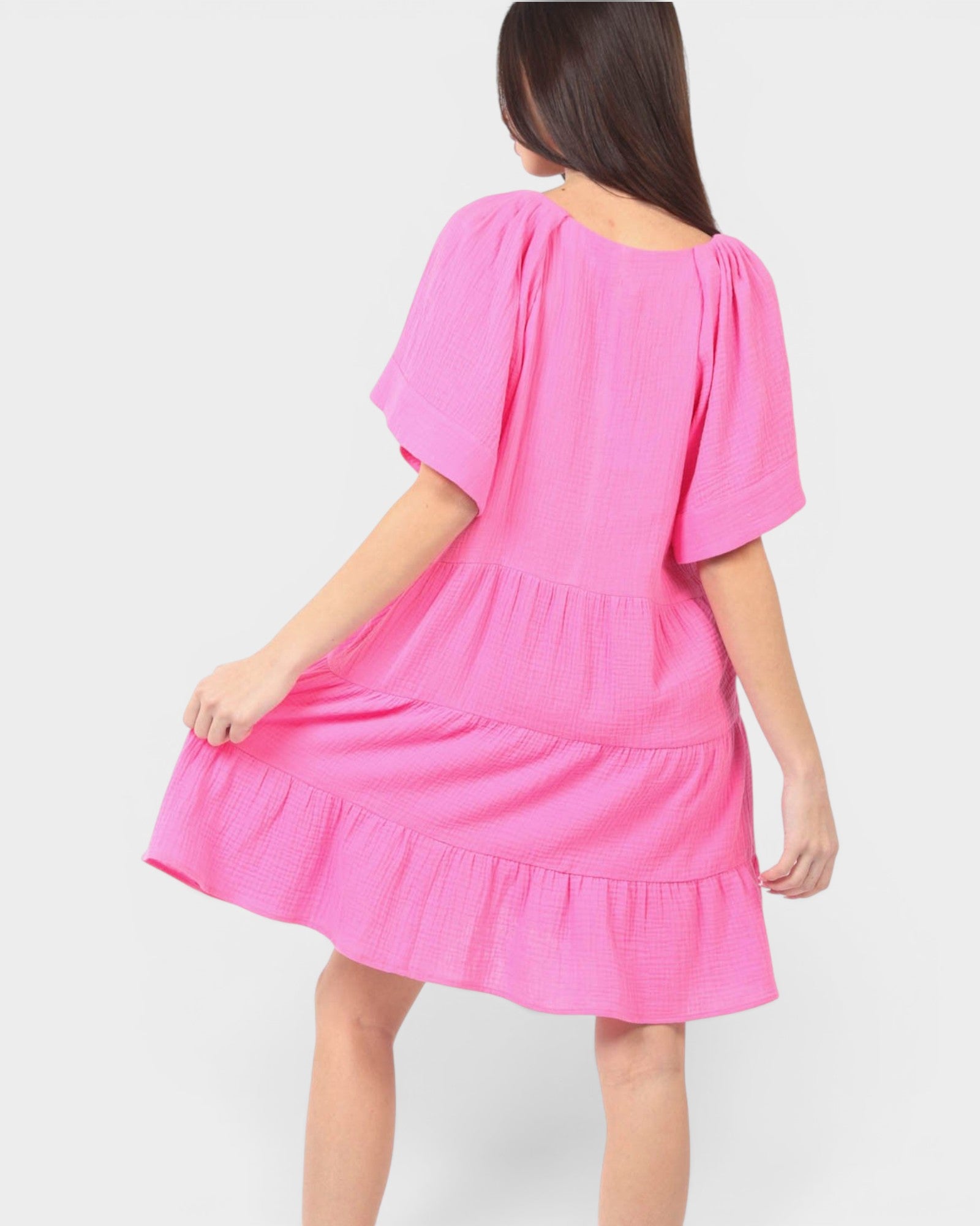 Pink dress worn by a person on a white background