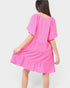 Pink dress worn by a person on a white background