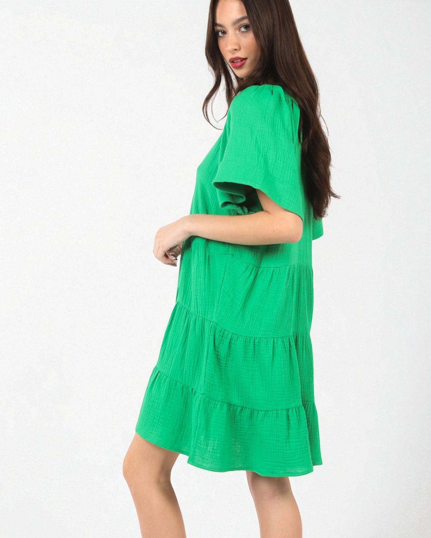Woman wearing a green dress on a white background