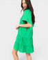 Green dress worn by a model on a white background