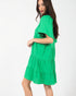 Woman wearing a green dress on a white background