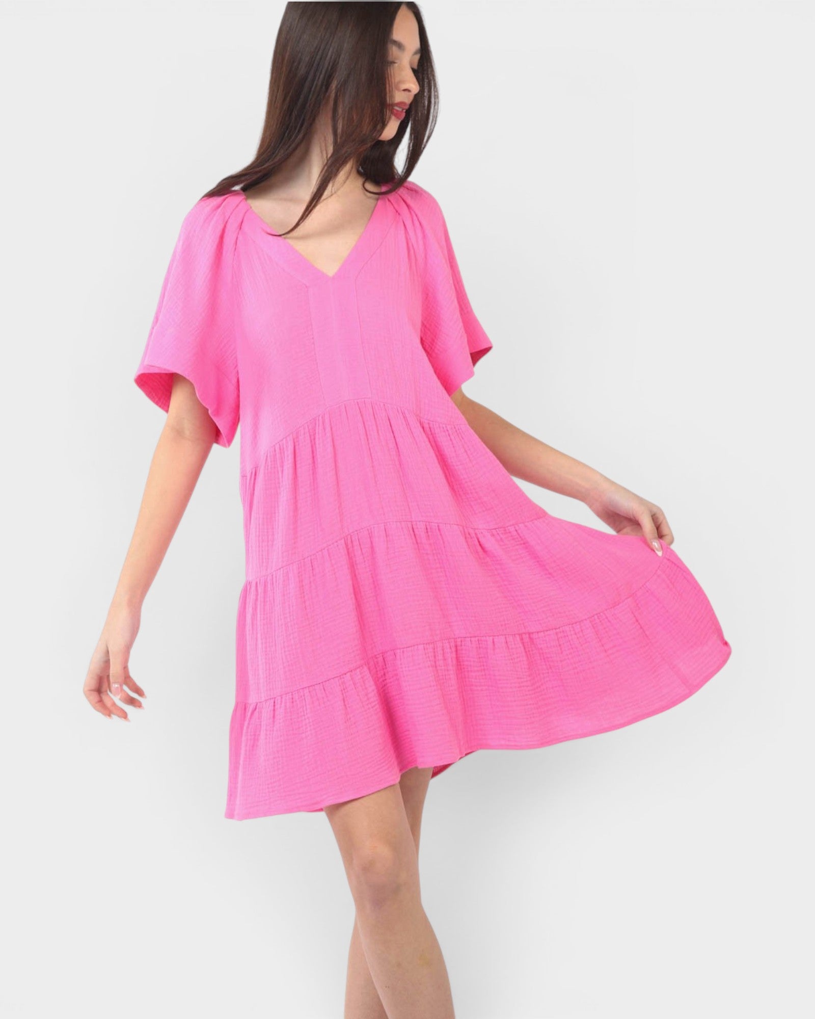 Woman wearing a pink dress on a white background