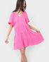 Woman wearing a pink dress on a white background