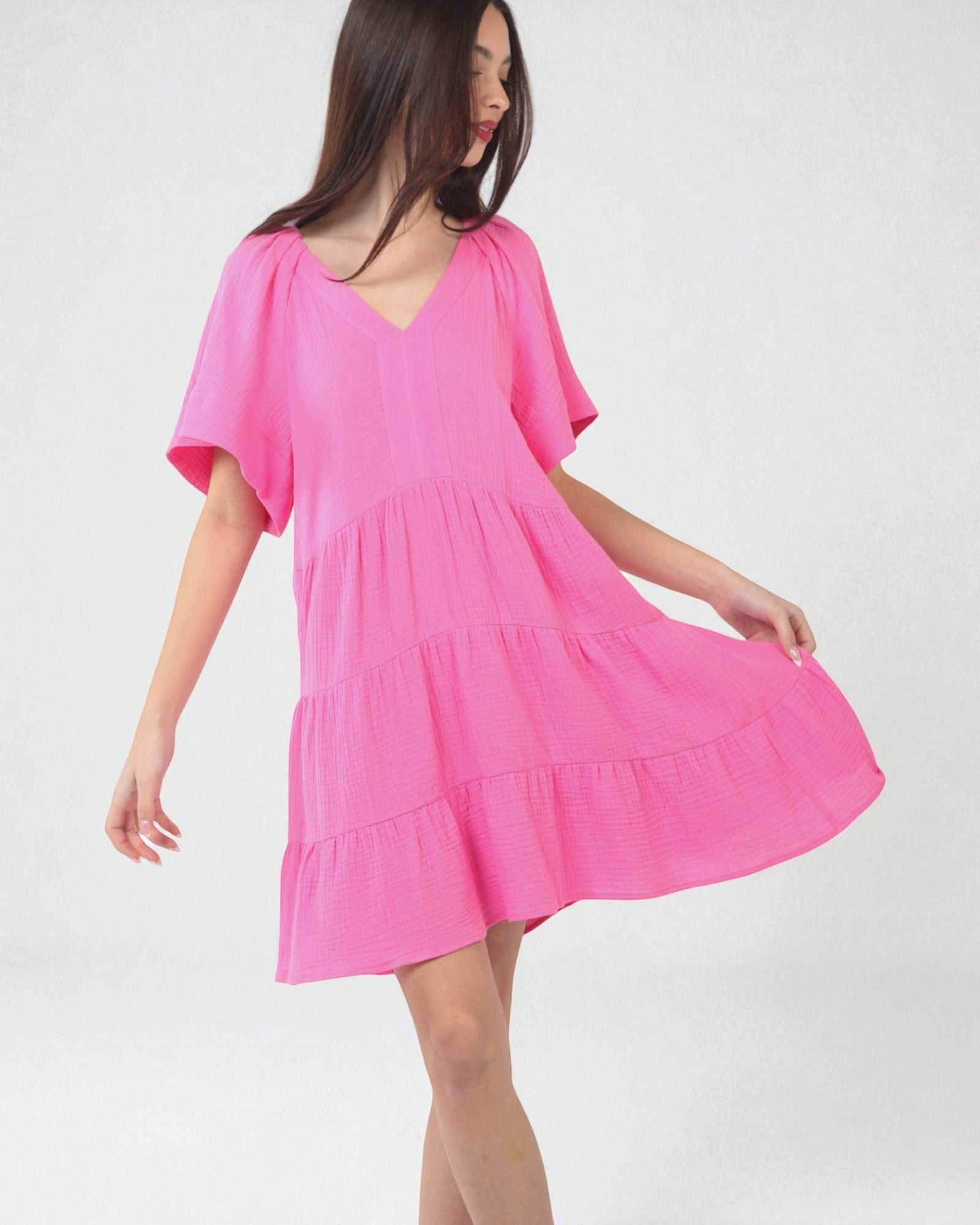 Woman wearing a pink dress on a white background