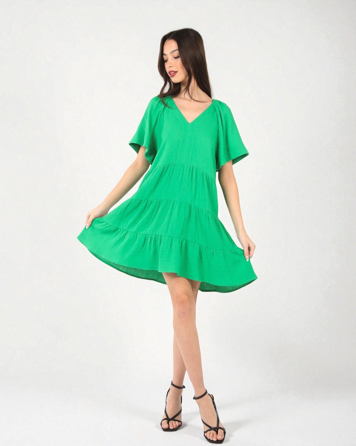 Woman wearing a green dress on a white background