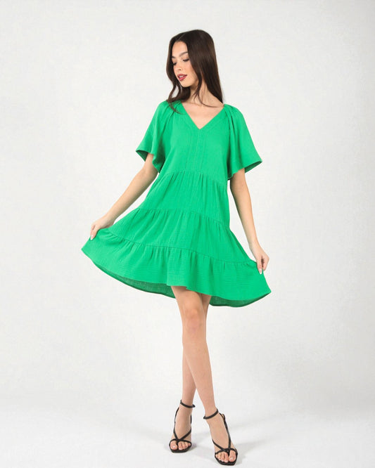 Woman wearing a green dress on a white background