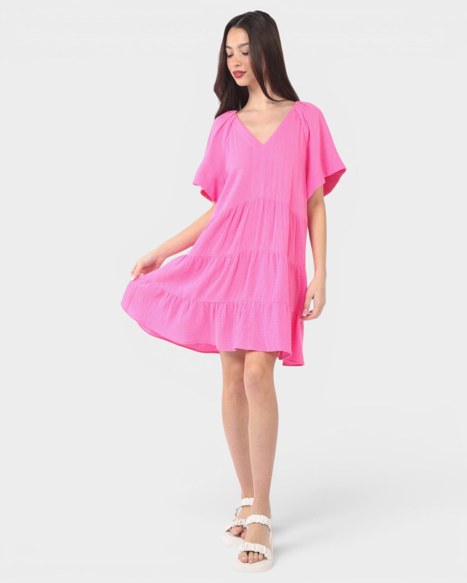 Woman wearing a pink dress on a white background