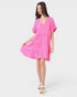 Woman wearing a pink dress on a white background