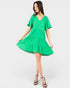 Woman wearing a green dress on a white background