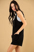 Woman wearing a black sleeveless dress with a beige background