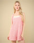 Woman wearing a pink and white striped dress against a beige background