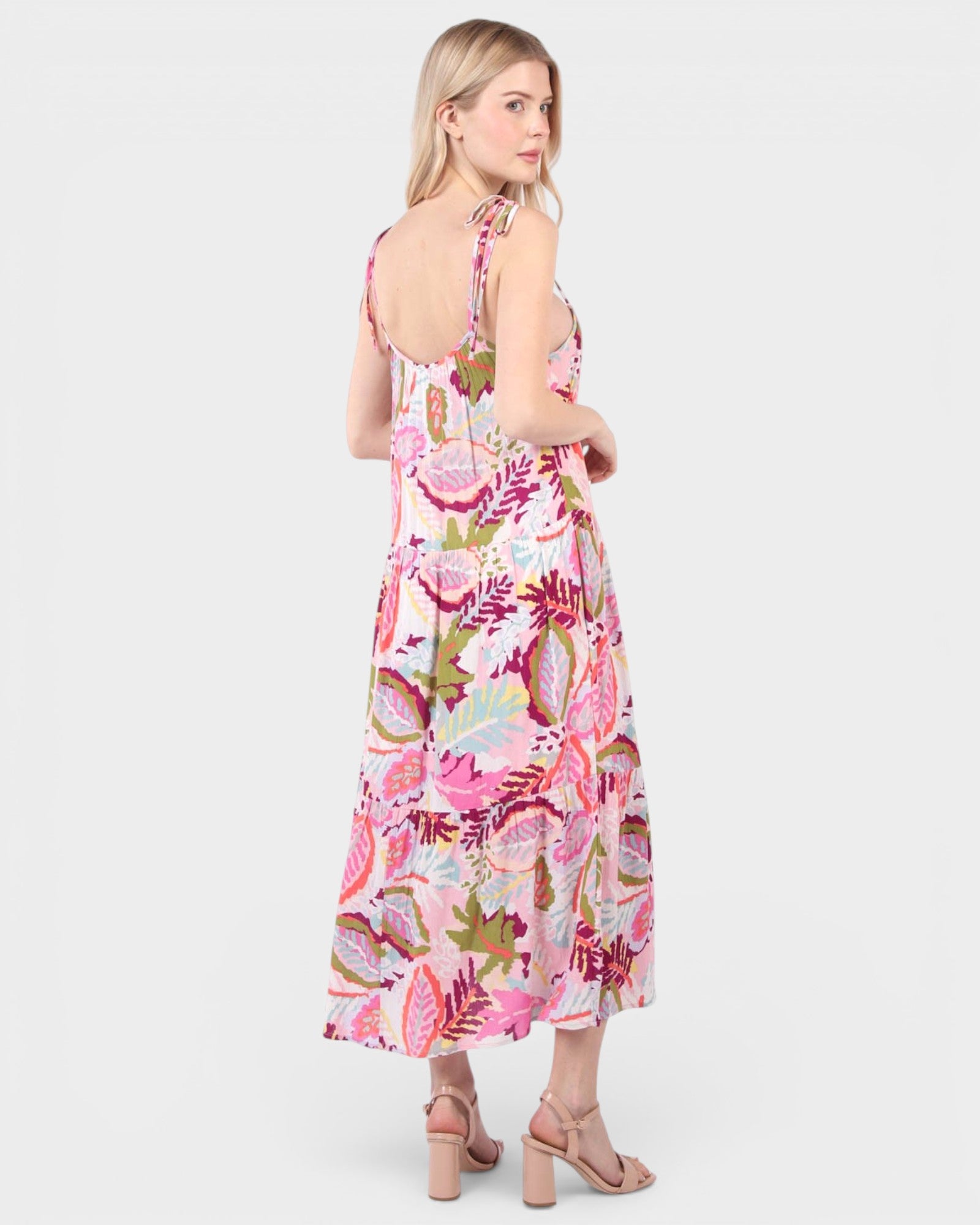 Woman wearing a pink floral dress on a white background