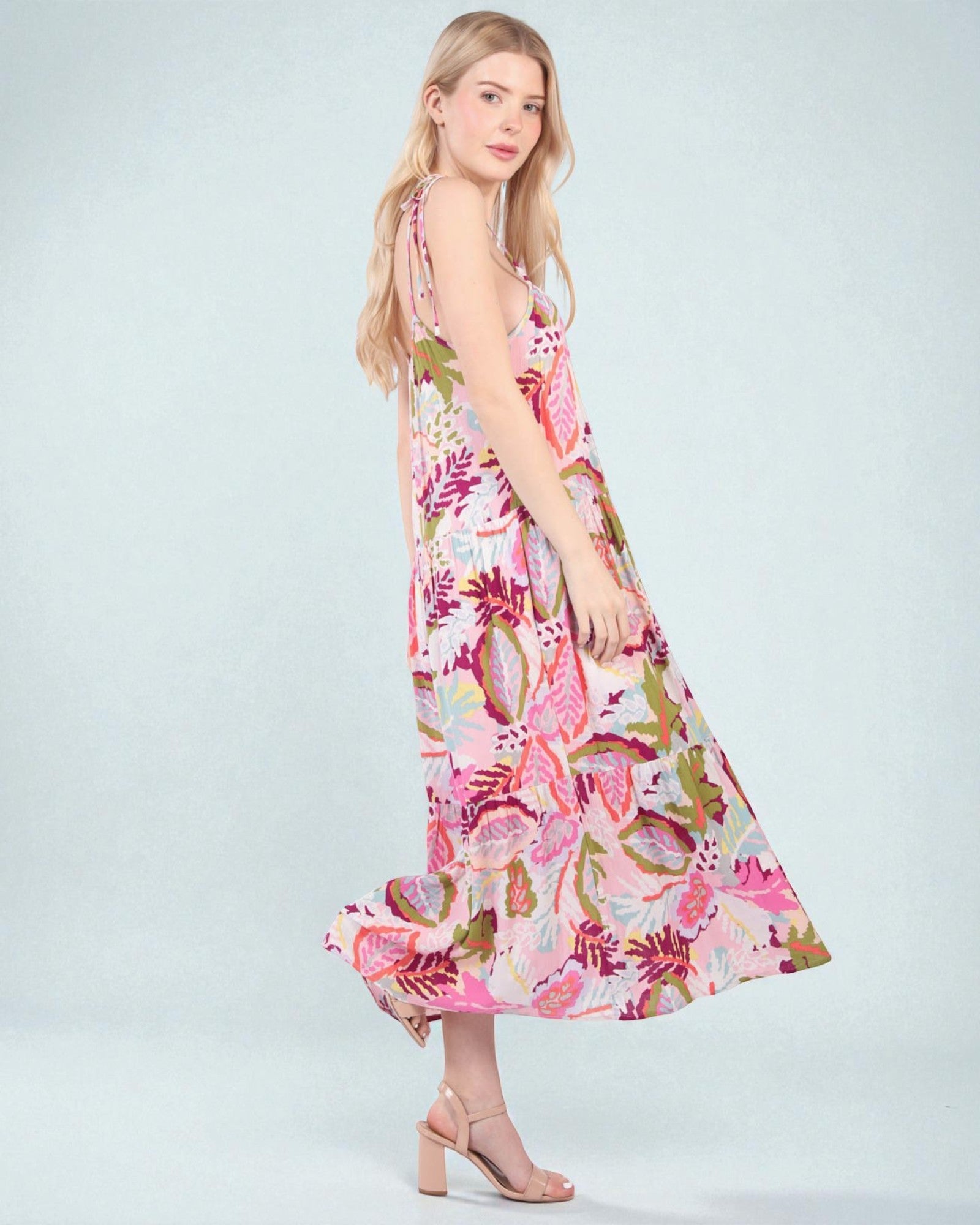 Woman wearing a floral dress on a light gray background