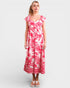 Woman wearing a pink and white floral dress on a white background