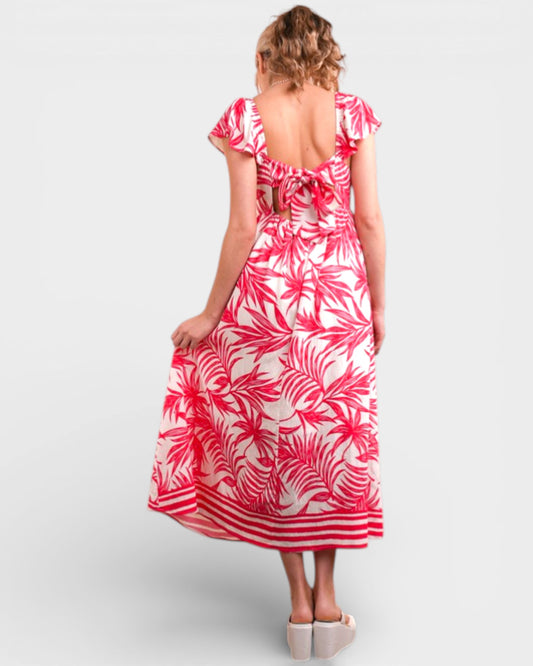 Woman wearing a pink and white floral dress on a white background