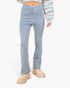 A model wearing light-wash blue flare jeans, a multicolor knit cropped sweater, and beige chunky platform boots against a plain white background.