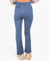 Rear view of a person wearing blue denim flare jeans with beige platform sandals against a plain light background.