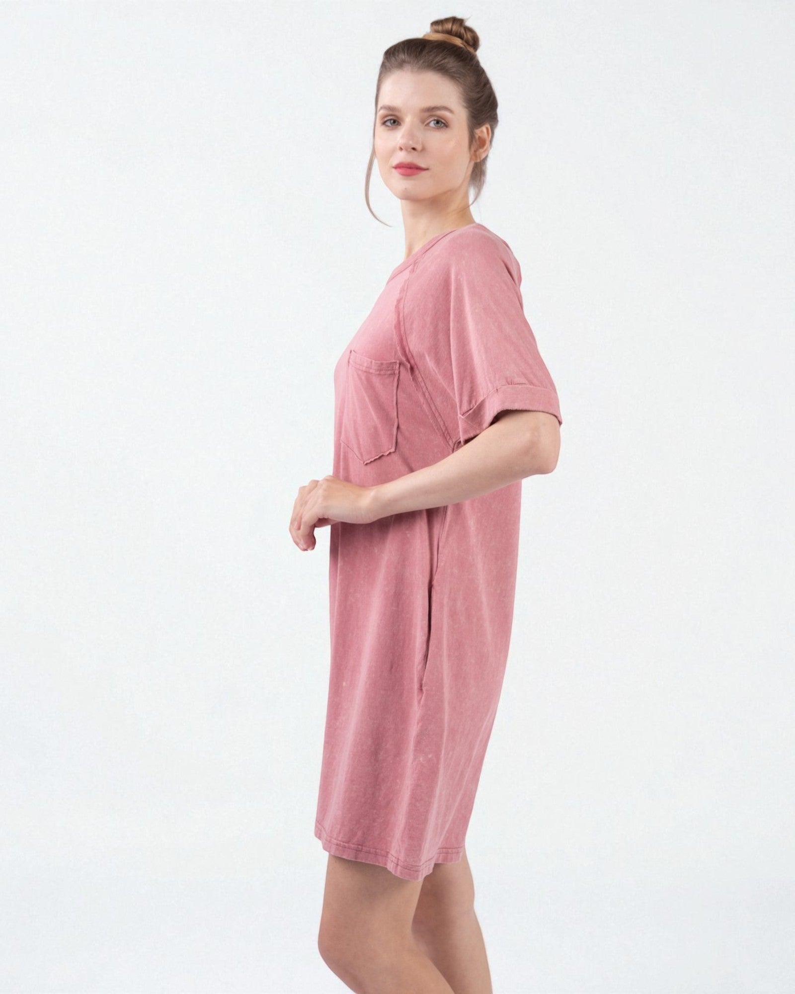 Woman wearing a pink dress against a white background