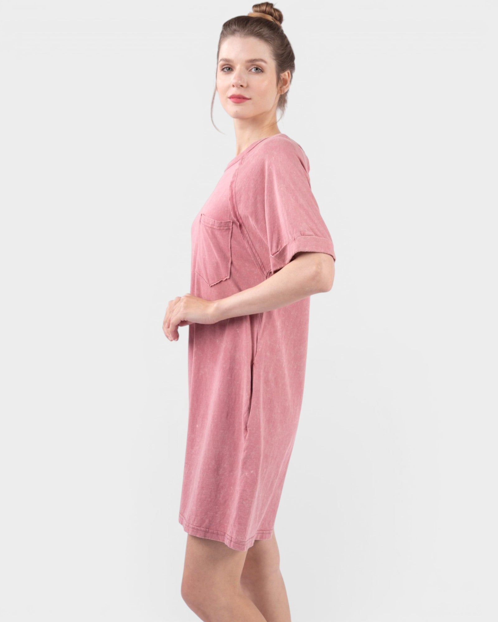 Woman wearing a pink dress on a white background