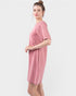 Woman wearing a pink dress on a white background