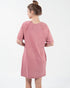 Woman wearing a pink dress on a white background