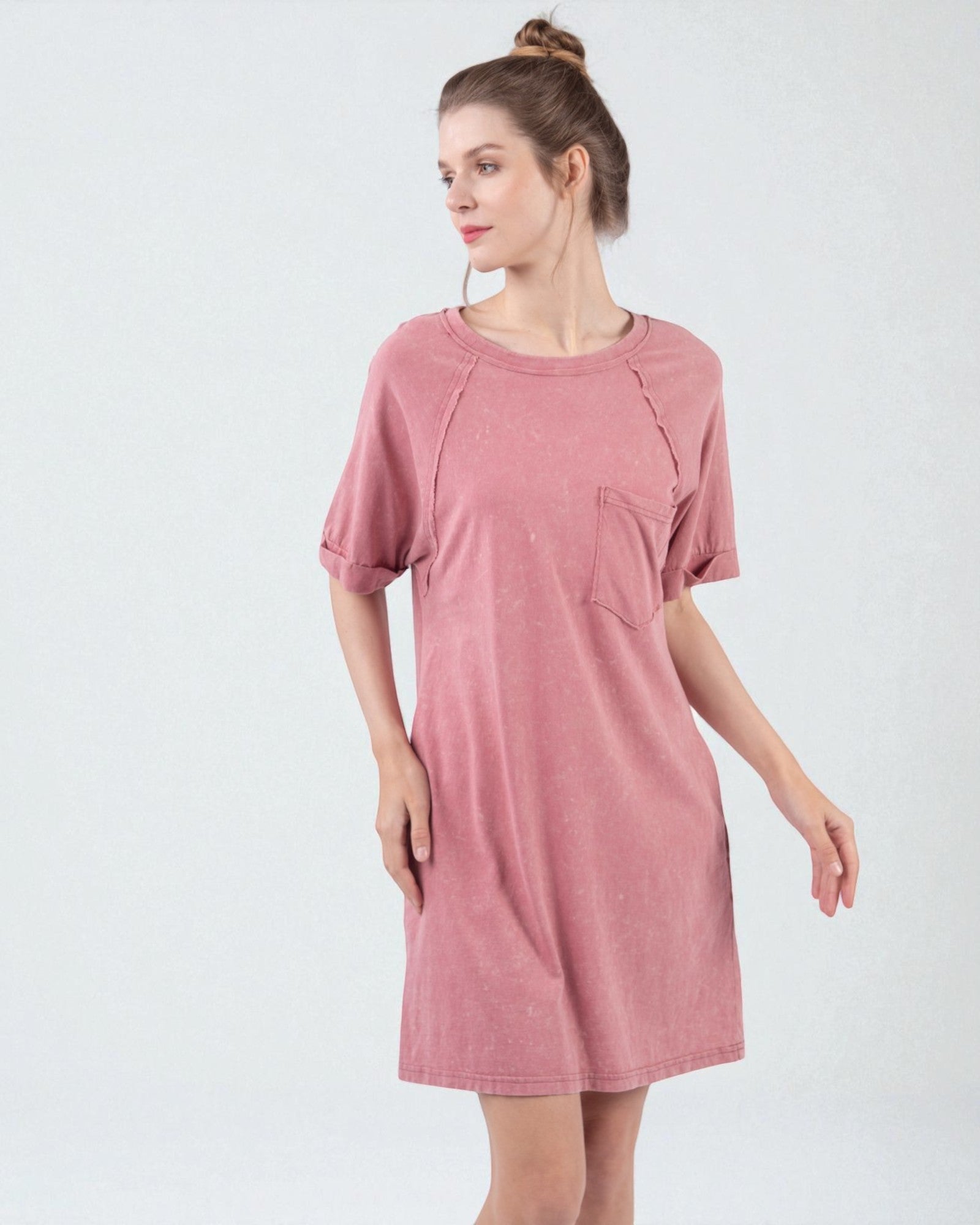 Woman wearing a pink dress on a white background