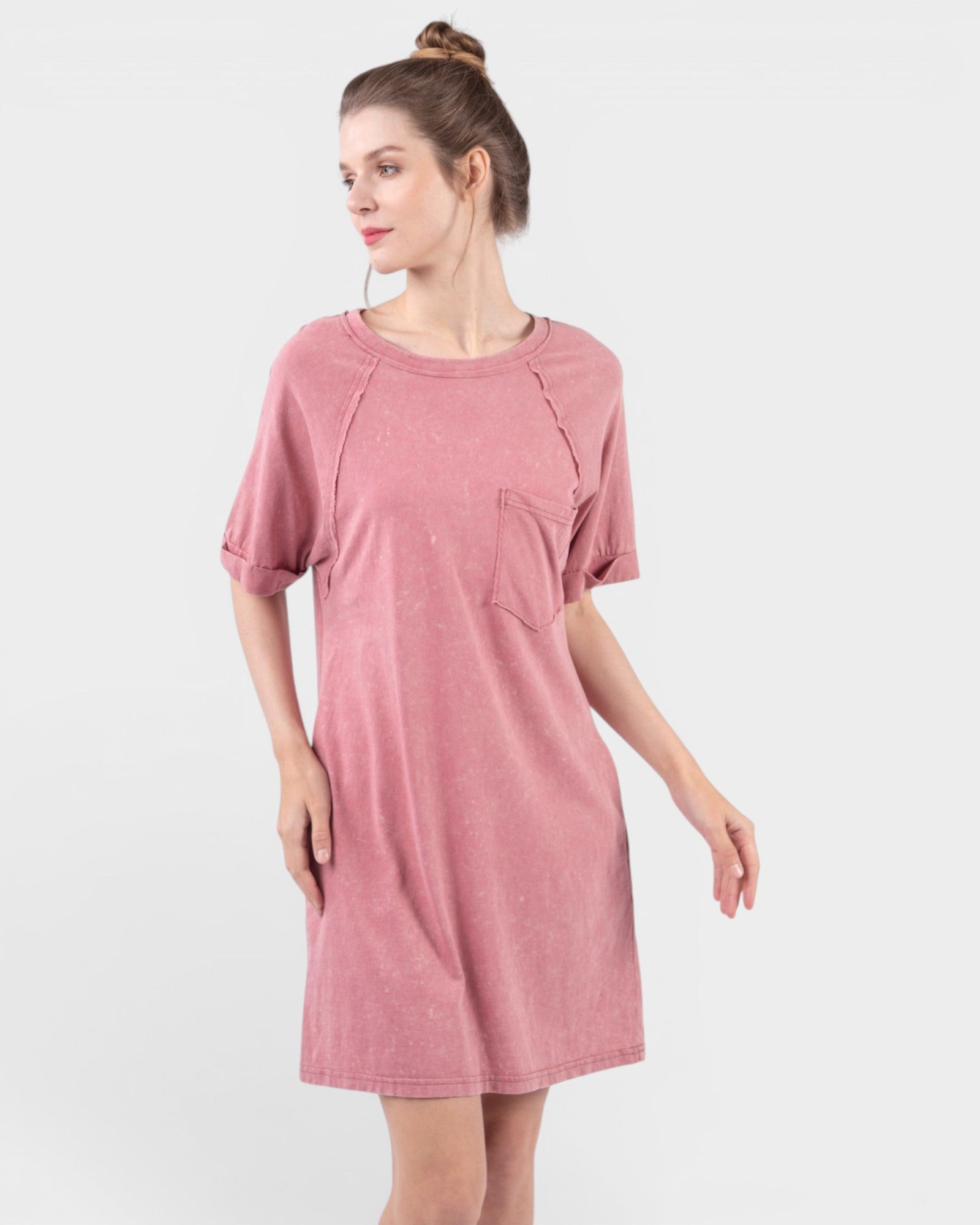 Woman wearing a pink dress on a white background