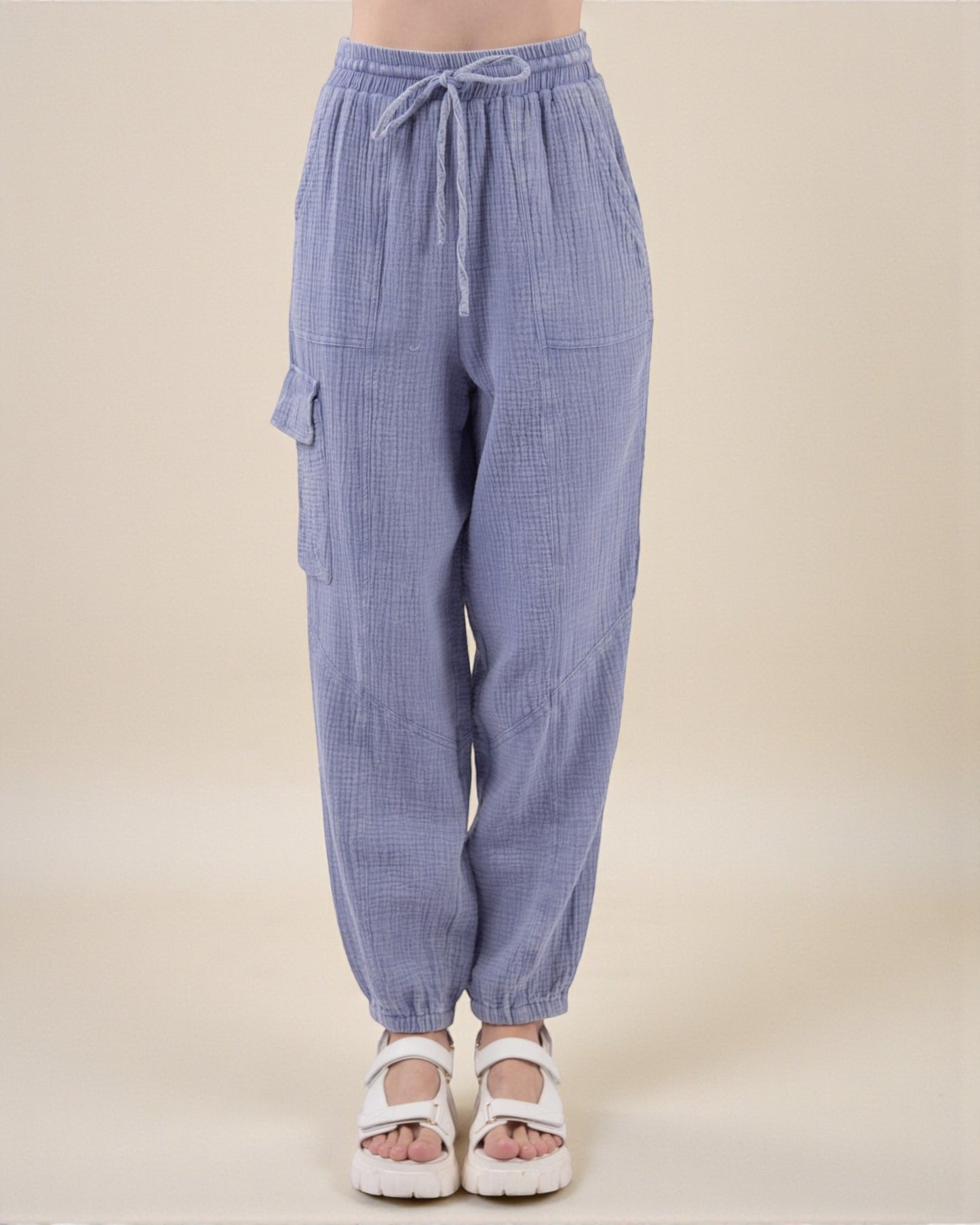 Blue checkered pants with drawstring waist on a beige background