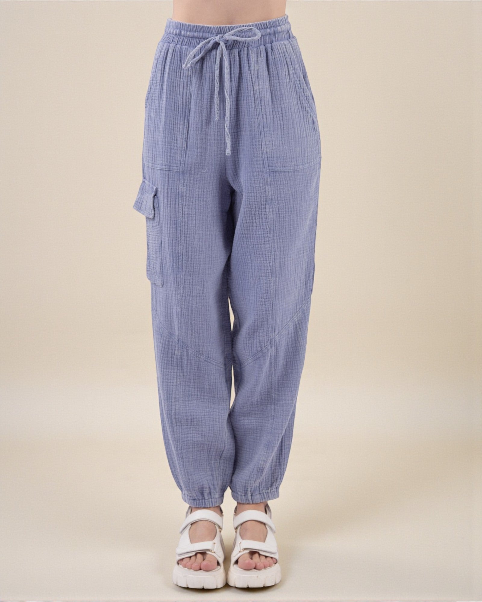 Blue checkered pants with drawstring waist on a beige background