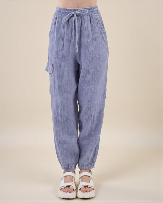 Blue checkered pants with drawstring waist on a beige background