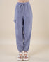 Blue checkered pants with drawstring waist on a beige background