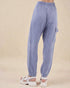 Blue checkered pants worn by a person on a beige background