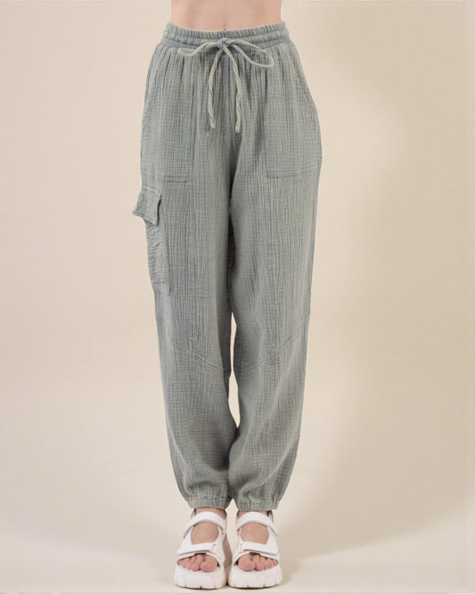 Green checkered pants with drawstring waist on a beige background