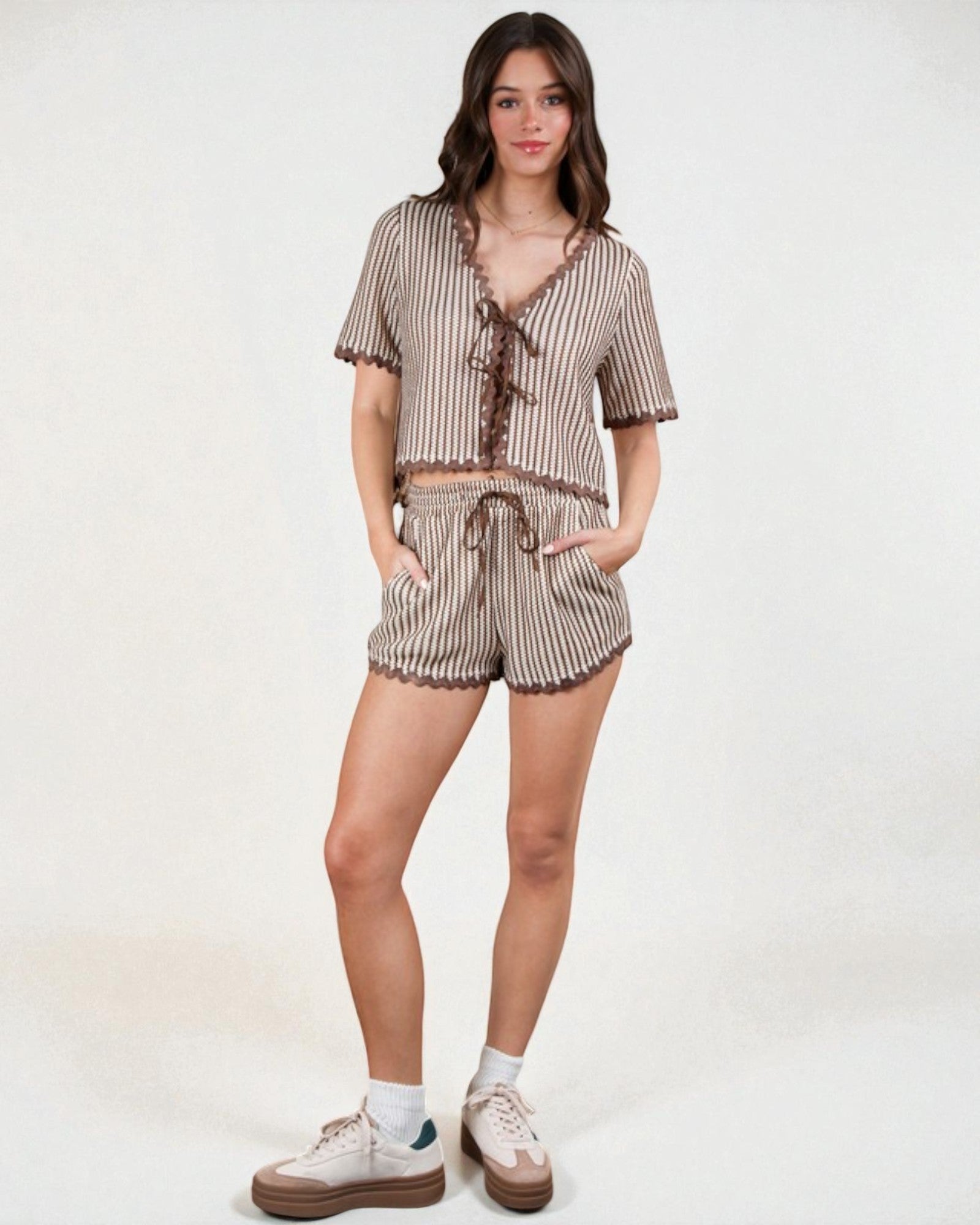 Woman wearing a striped pajama set on a white background