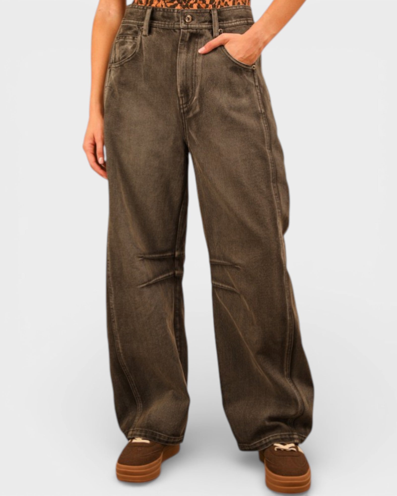 Brown wide-leg pants worn by a person on a light gray background