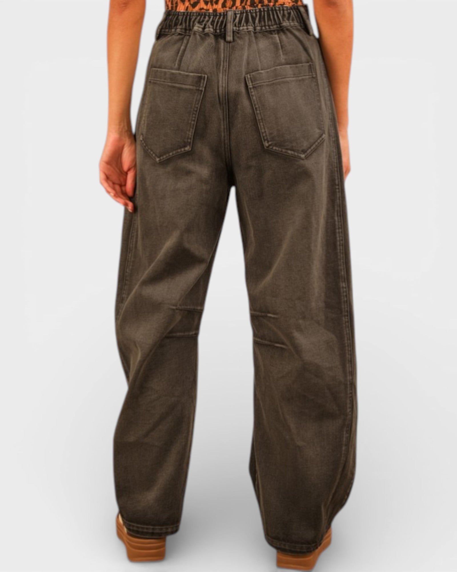 Brown wide-leg pants worn by a person on a light gray background