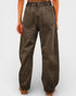 Brown wide-leg pants worn by a person on a light gray background