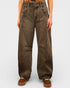 Brown wide-leg jeans worn by a person on a white background