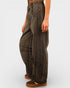Brown cargo pants worn by a person on a white background