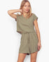 A woman modeling a matching two-piece olive green romper set consisting of a short-sleeve cropped top and high-waisted shorts with a tie belt, against a plain white background.