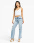 A woman modeling a pair of light-wash, high-rise, distressed straight-leg jeans with a white crop top and platform sandals against a plain white studio background.